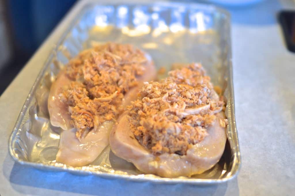 Crab stuffing gets lightly packed into chicken breast  