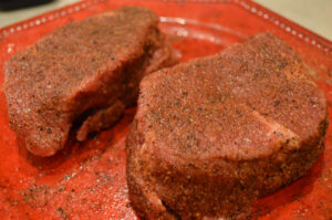 seasoned steaks on plate