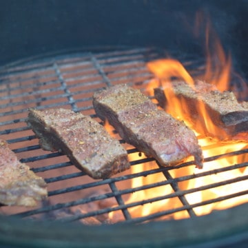 Beef Short Ribs Getting Seared Over Hardwood Lump Charcoal