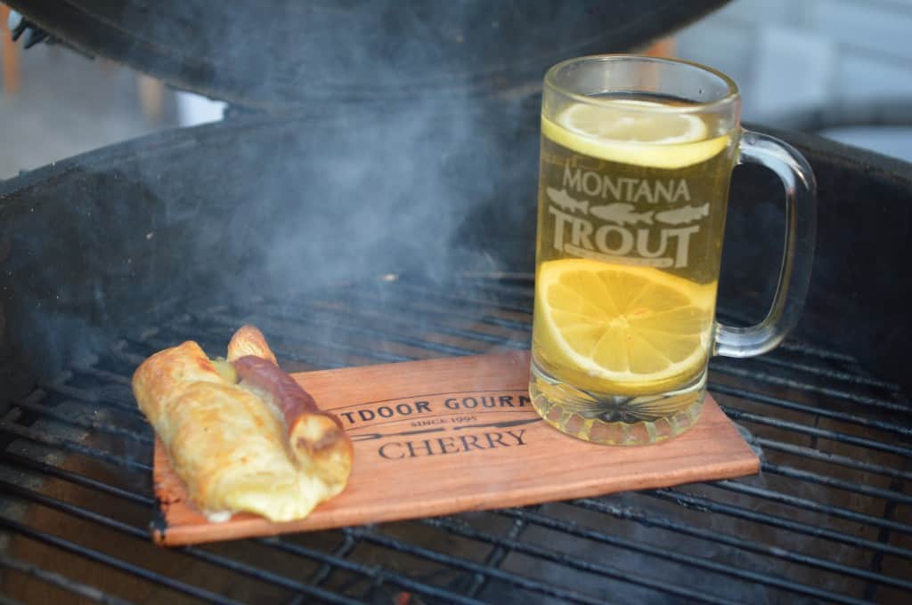Puff Pastry Appetizer Cooking Next to a Hot Toddy on the Grill Plank