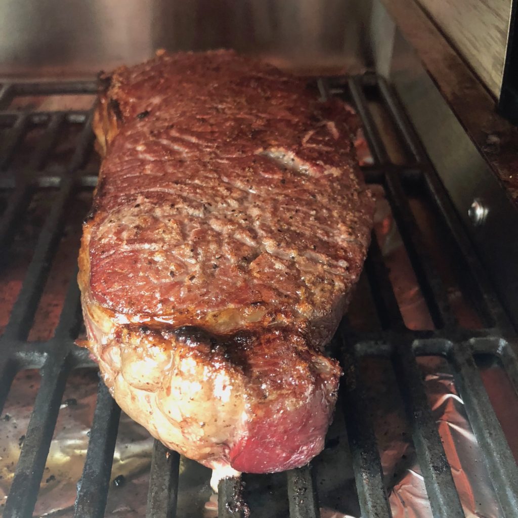 grass-fed beef steak under broiler 
