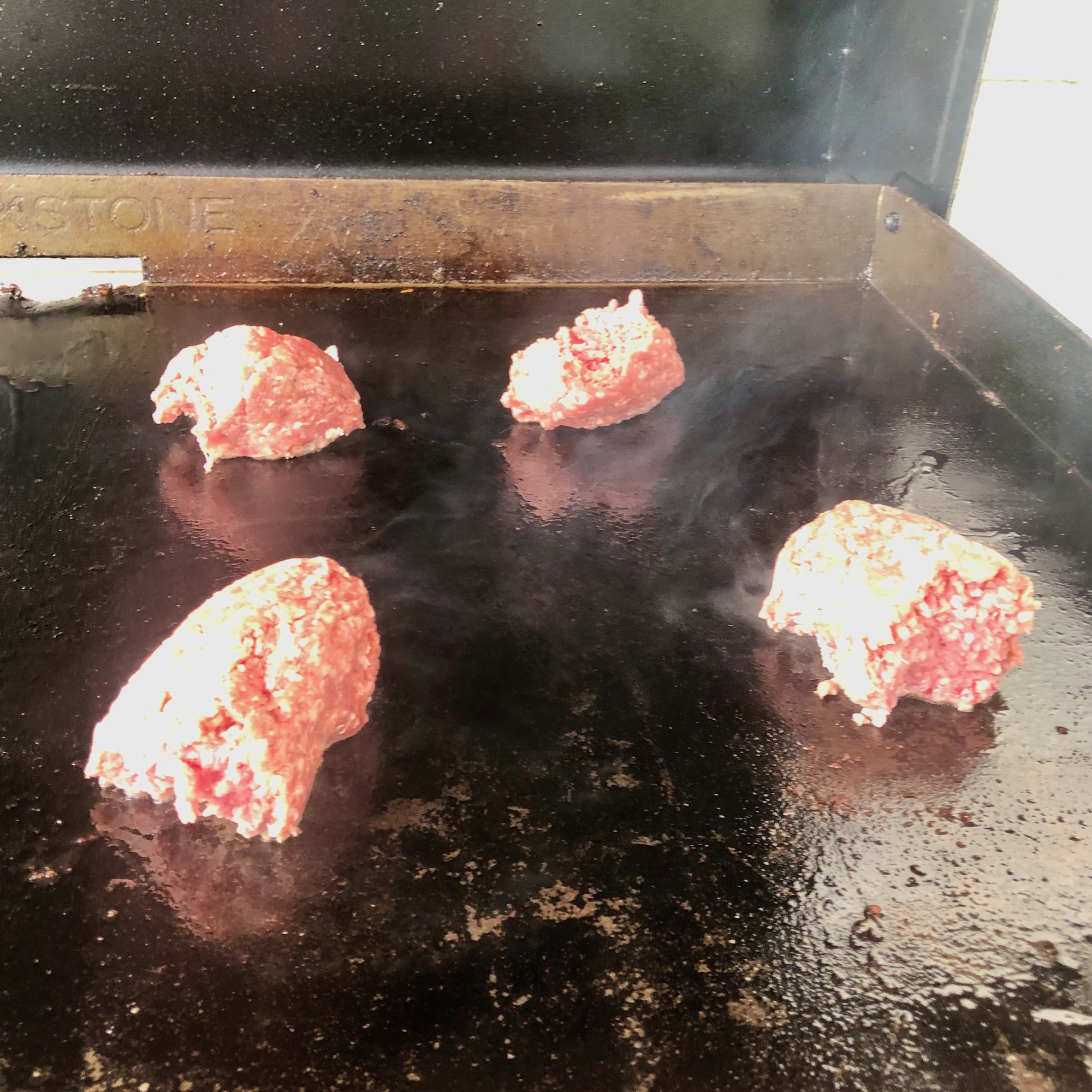 burger meat on griddle