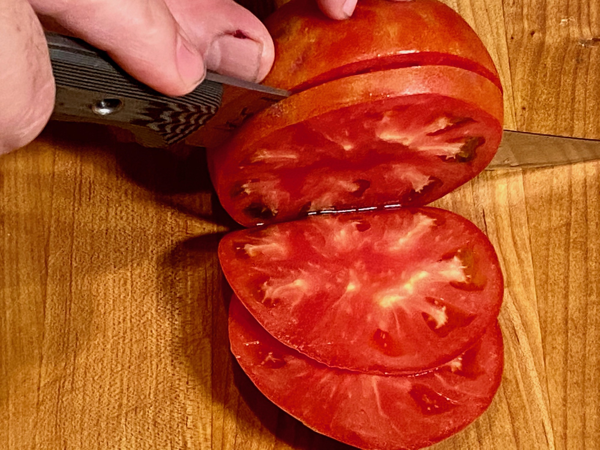 slicing tomato with sharp knife