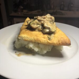 mushrooms on crescent roll dough with mashed potato