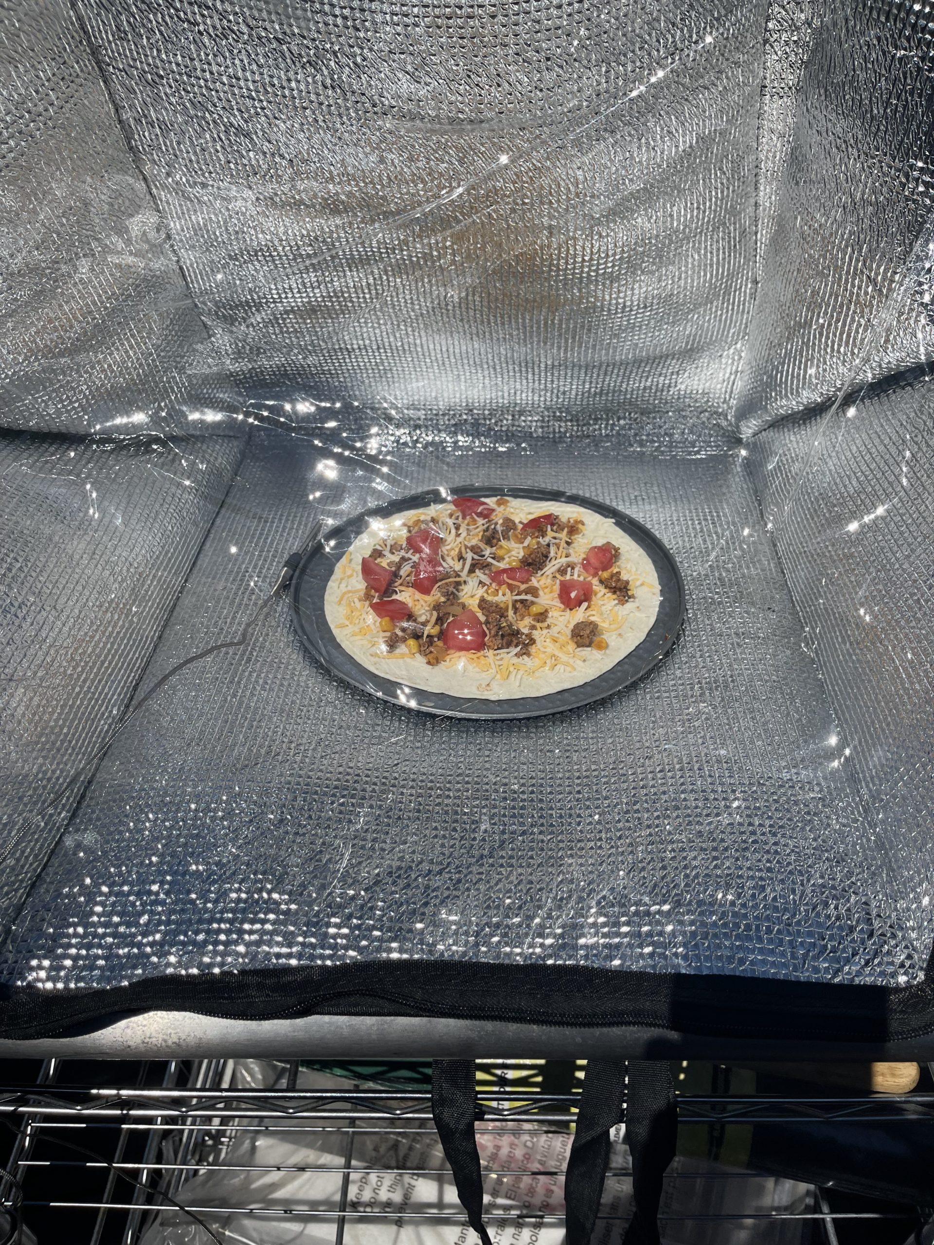 A Mexican pizza cooking in the solar oven