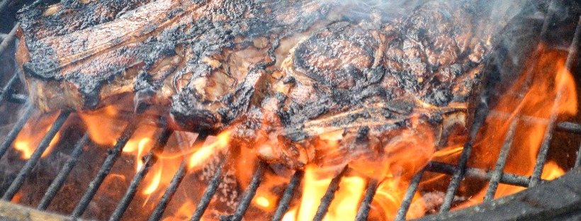 meat cooking over charcoal